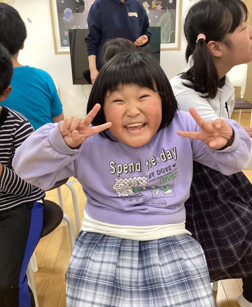 小さな女の子がピースをしている